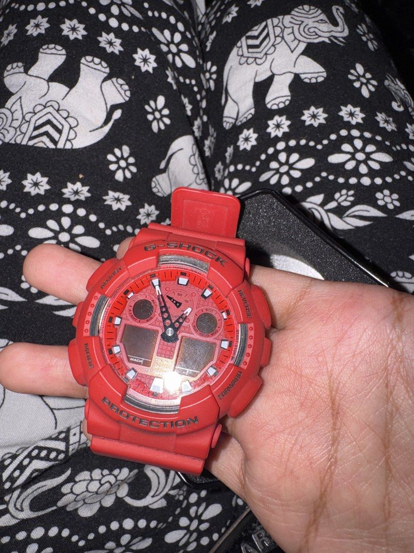 Casio G-Shock GA-100C Red Analog Digital Watch (Category: Men's Watches) located in Taguig. Submitted by cassie.bear (Listing ID 1468103667, Image 3). Description: - Brand: Casio G-Shock - Model: GA-100C (Bright Red) - Display: Combination analog and digital with black and white dials - Build: Heavy-duty resin strap and bezel with stainless steel back case - Water Resistance: Up to 20 bar - Inclusions: Original black hexagonal tin case - Conditio