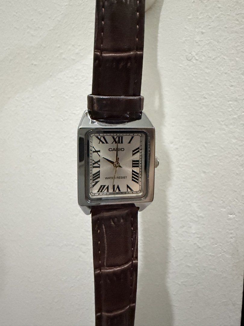 Casio Tank Roman Numeral Watch Brown Leather Strap (Category: Women's Watches) located in Pasay City. Submitted by gerlynnedc (Listing ID 1468211341, Image 2). Description: - Brand: Casio Tank Watch - Dial: Silver with classic black Roman numerals and minimalist hands - Case: Silver-tone rectangular case - Strap: Dark brown faux-croc leather strap - Movement: Reliable quartz movement with water resistance - Style: Vintage dress watch vibe, ideal 