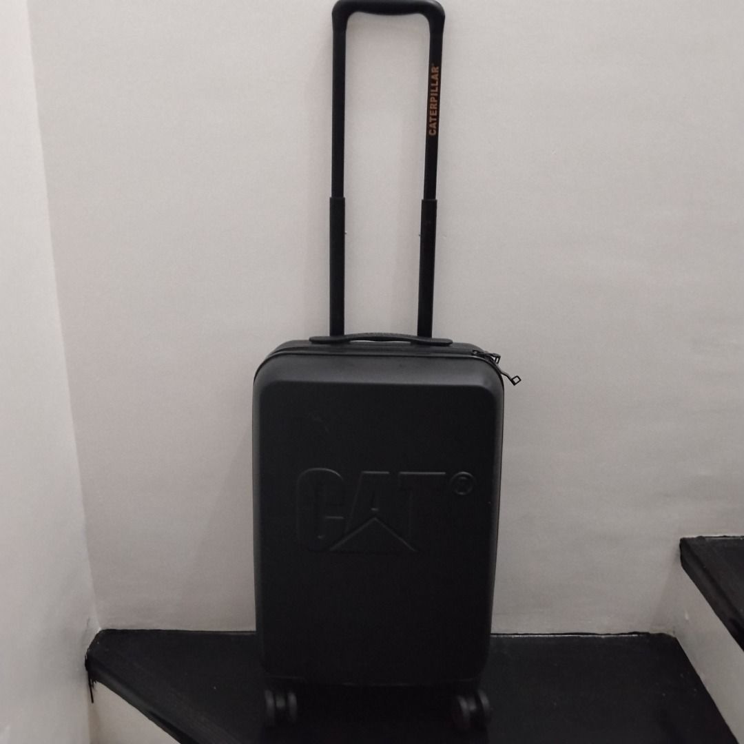 CAT Black Hard Shell Suitcase Trolley Luggage (Category: Luggage) located in Cavite. Submitted by msgs_2827 (Listing ID 1468116404, Image 1). Description: For Sale: CAT 20 inch Cabin Luggage Color: Black Condition: Only used once - in very good condition! Actual Measurements (including the wheels): Height: 21 inches Width: 14 inches Depth: 8 inches - Color: Sleek black with a prominent embossed Caterpillar (CAT) logo - Mobility: Smooth telescopic