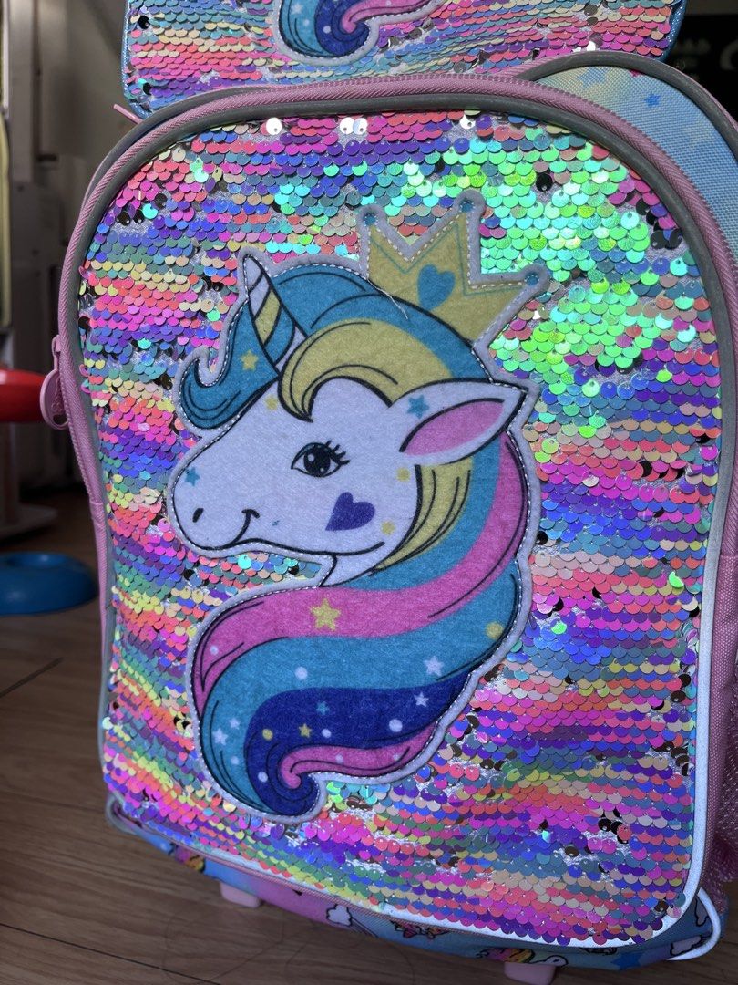 CCJPX Unicorn Rolling Backpack Lunch Bag Pencil Case Set (Category: Stationery & School Supplies) located in Manila. Submitted by shiellapreloved (Listing ID 1468177874, Image 3). Description: Pre-loved. Like new. Price still negotiable. - 3-in-1 school set: Rolling backpack, matching lunch box, and pencil pouch - Eye-catching pink unicorn design with fun reversible sequins - Pastel rainbow background featuring stars, clouds, and ice cream graphi