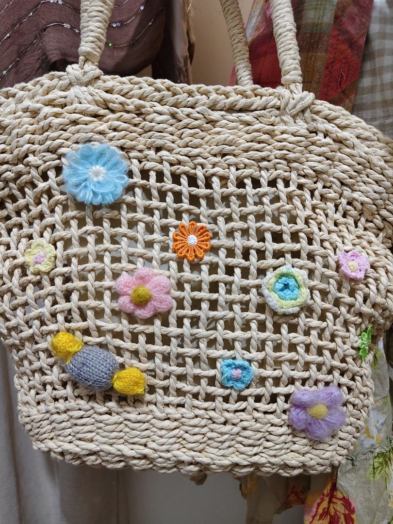 CD:B03 Cottage core rattan shoulder bag (Category: Shoulder Bags) located in Manila. Submitted by chynii_28 (Listing ID 1468136094, Image 3). Description: - Style: Cottagecore rattan shoulder bag (CD:B03) - Design: Cream-colored woven rattan with colorful crochet flowers and a front candy accent - Dimensions: 10" Length x 10" Height x 15" Width - Strap: 17" shoulder strap drop - Closure: Secure zip closure - Condition: Stains present on the inner