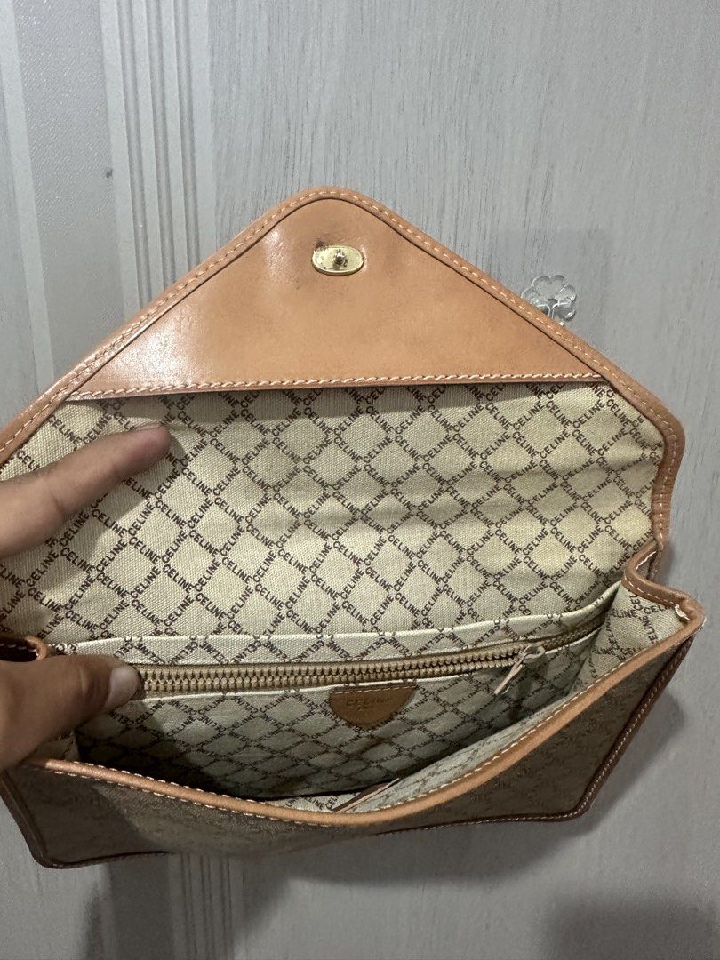 Celine Macadam Envelope Clutch Bag (Category: Luxury Bags & Wallets) located in Digos. Submitted by reywearfinds (Listing ID 1468142293, Image 2). Description: - Authentic Celine envelope clutch bag - Iconic beige & brown Macadam canvas with tan leather trim - Elegant gold-tone hardware and secure snap closure - Signature Celine logo fabric interior lining - Interior zippered pocket with 'CELINE PARIS - MADE IN ITALY MO5' leather stamp - Roomy de