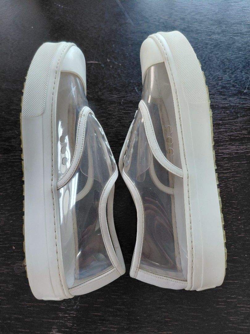 Celine Paris Clear White Sneakers (Category: Sneakers) located in Baguio. Submitted by undressme24 (Listing ID 1468154520, Image 3). Description: - Brand: Celine Paris - Style: Transparent slip-on sneakers with white leather trim and toe cap - Details: Decorative eyelets, side perforation, and honeycomb traction rubber platform sole - Branding: Celine logo stamped on the insole and heel counter - Condition: Excellent buyer-friendly ready-to-wear 
