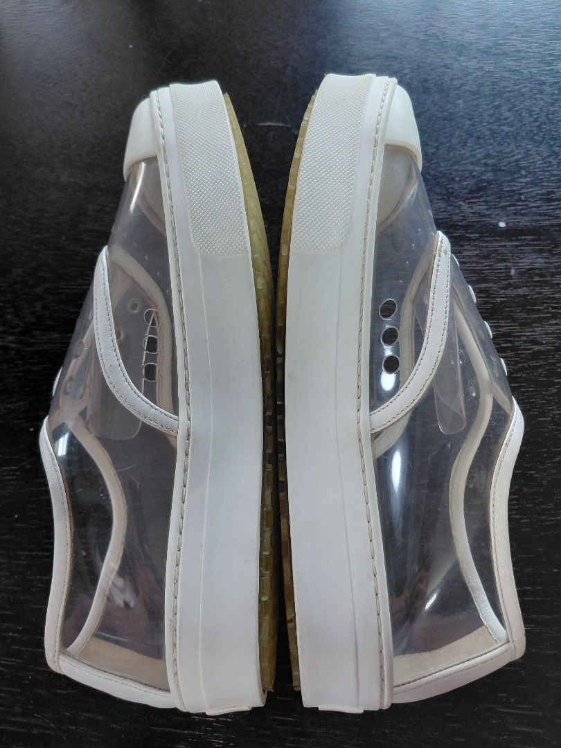 Celine Paris Clear White Sneakers (Category: Sneakers) located in Baguio. Submitted by undressme24 (Listing ID 1468154520, Image 2). Description: - Brand: Celine Paris - Style: Transparent slip-on sneakers with white leather trim and toe cap - Details: Decorative eyelets, side perforation, and honeycomb traction rubber platform sole - Branding: Celine logo stamped on the insole and heel counter - Condition: Excellent buyer-friendly ready-to-wear 