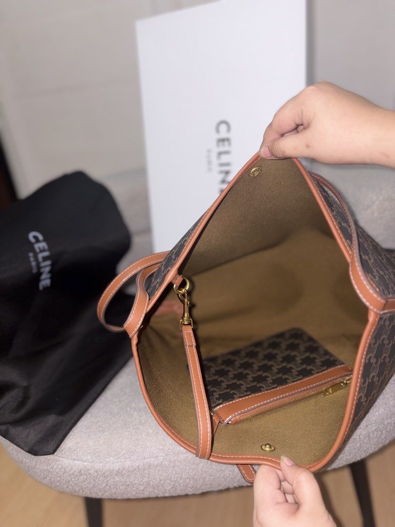 Celine Triomphe Canvas Cabas Tote Bag (Category: Tote Bags) located in Manila. Submitted by axchichaaa (Listing ID 1468177964, Image 3). Description: - Authentic Celine Triomphe Canvas Cabas Tote - Color: Brown with tan leather trim - Features open top with secure snap button closure - Includes matching zippered pouch attached inside - Clean interior lining - Tan leather shoulder strap for comfortable wear - Comes complete with black dust bag and