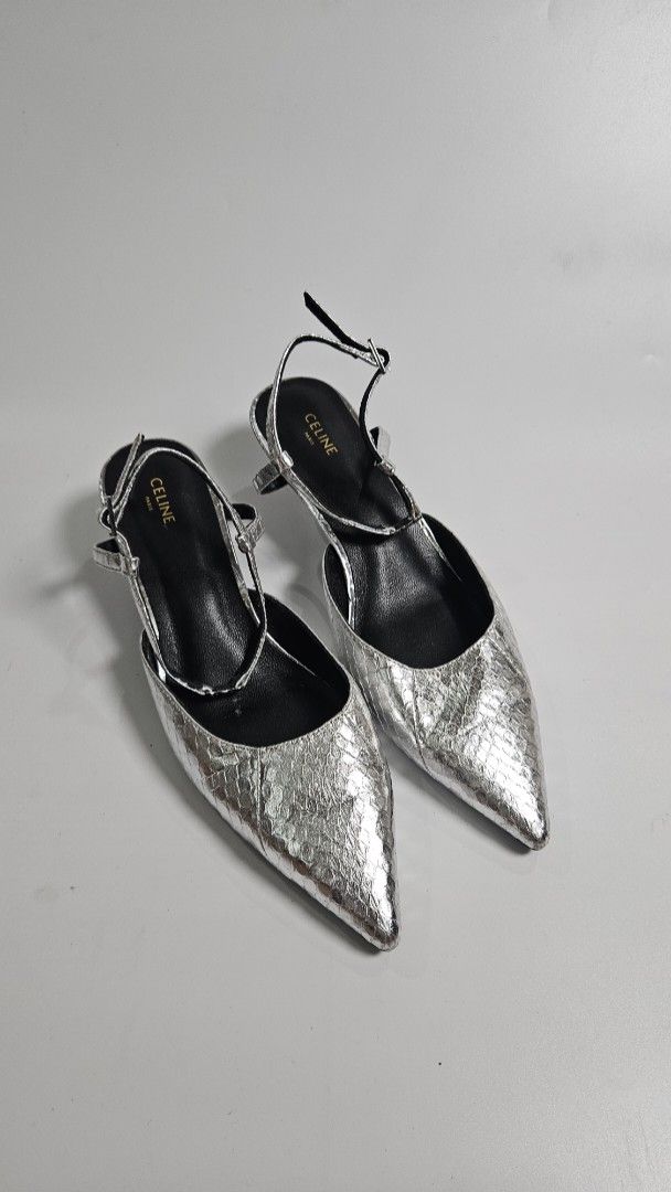 Celine Triomphe Patent Leather Slingback Pumps (Category: Heels) located in Alfonso. Submitted by jbcamet (Listing ID 1468192373, Image 1). Description: - Brand: Celine - Style: Metallic textured slingback heels with pointed toe and kitten heel - Size: 39 (Made in Italy) - Details: Delicate ankle straps with Celine-branded buckles, black insoles with gold foil logo - Condition: Pre-loved with scuffs on the leather soles - Perfect for elevating bo