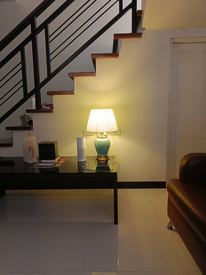 Ceramic Table Lamp with Pleated Shade and Gold Base (Category: Lighting) located in Las Pinas. Submitted by jenny.nogu (Listing ID 1468164896, Image 2). Description: - Elegant green ceramic body with shiny gold hardware - Pleated fabric shade that casts a warm, cozy glow - Standard plug-in cord, tested and in good working condition - Perfect size for bedside or living room side tables - Note: Glass-topped table and speaker shown in photo are not 