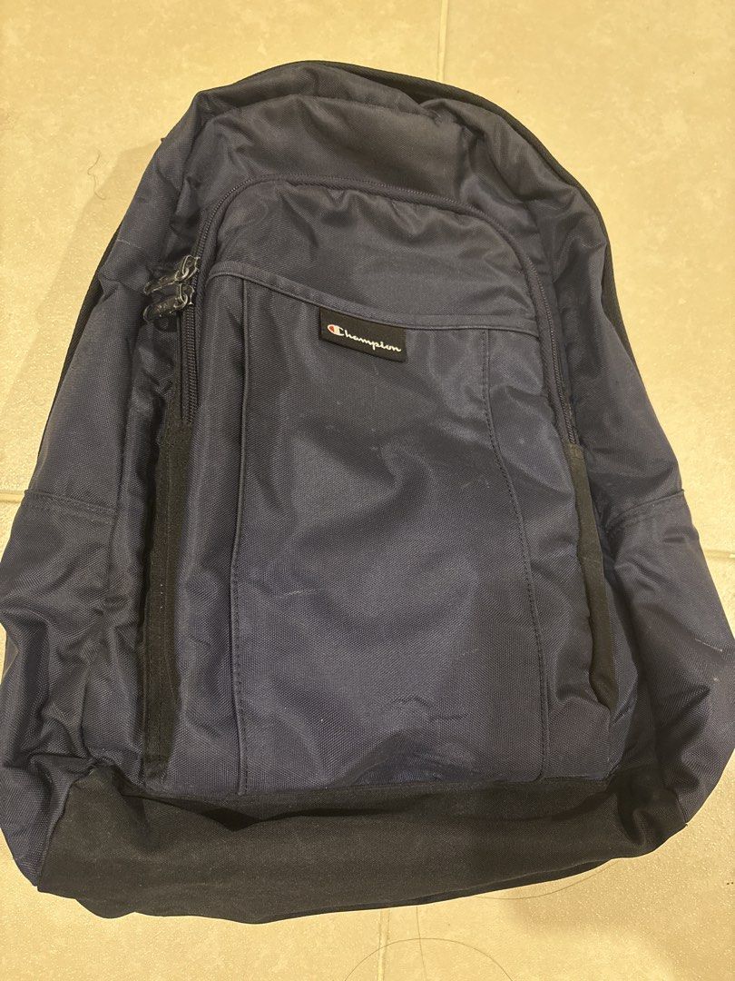 Champion Navy Blue Backpack (Category: Backpacks) located in Manila. Submitted by loislane112233 (Listing ID 1468188451, Image 1). Description: - Color: Classic Navy Blue with a durable black base panel - Branding: Iconic Champion logo patch on the front zipper pocket - Storage: Multiple compartments to easily organize your everyday gear - Comfort: Adjustable shoulder straps for a custom, comfortable fit - Versatility: Solid and reliable construc