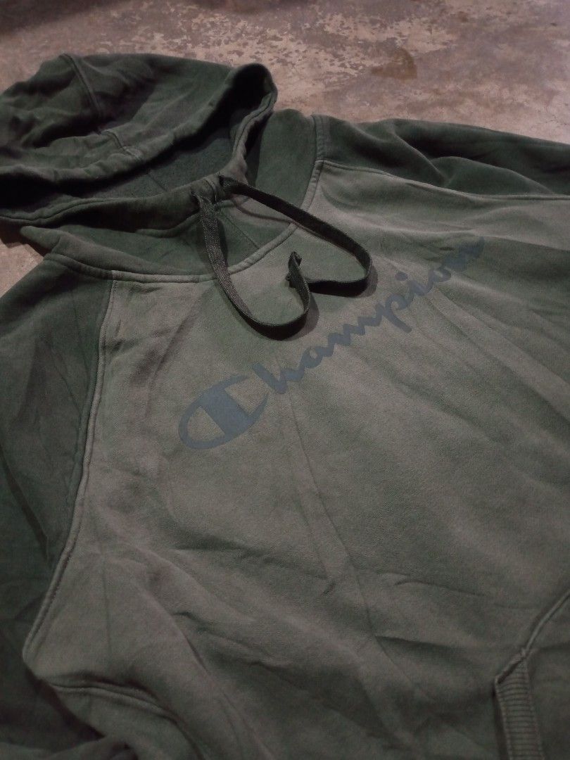 Champion Script Pullover Hoodie Olive Green (Category: Coats, Jackets and Outerwear) located in Cabuyao City. Submitted by kenzu_stuff (Listing ID 1468090435, Image 3). Description: Champion Script Pullover Hoodie Olive Green - Size: XL on tag, M-L fittings - Length: 26" - Width: 23" - Issue: NONE - Condition: Good - Color Rate: 9.8/10 - Color may vary due to lighting. - Thrifted item(s), please manage your expectations. We do shipping nationwide