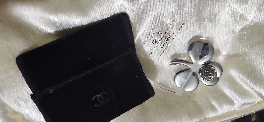 Chanel Clover Brooch Pin with Pouch (Category: Brooches) located in Caloocan City. Submitted by refreshmycloset444 (Listing ID 1468248381, Image 1). Description: - Authentic Chanel skincare promotional four-leaf clover brooch - Elegant silver-tone metal finish with a delicate CC logo in the center - Brand new and still sealed in its original clear plastic packaging - Includes a luxurious black velvet storage pouch with the embossed Chanel logo - 
