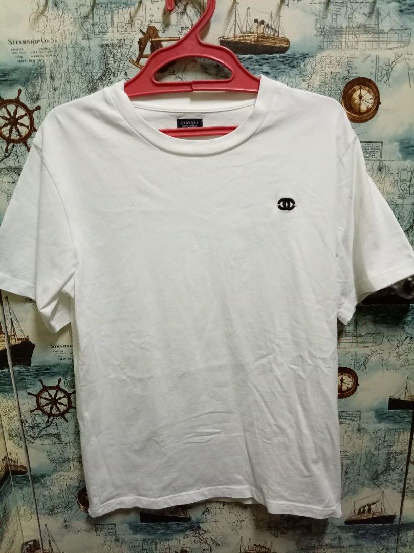 Chanel Uniform White T-Shirt Size 50 (Category: Shirts) located in Baguio. Submitted by jnjayceelbrn (Listing ID 1468172984, Image 1). Description: - Authentic white Chanel uniform crewneck t-shirt - Short sleeves with printed Chanel label on the right - Subtle embroidered CC logo on the chest - Tagged Size 50 at the collar - Clean white fabric, perfect as a simple everyday luxury piece - Includes interior care label with washing instructions.