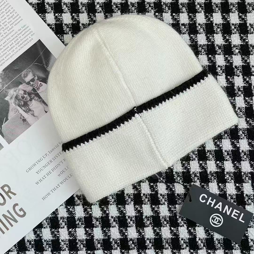 Chanel white and black knit beanie hat (Category: Hats & Beanies) located in Caloocan City. Submitted by rarisganiy26807 (Listing ID 1468132620, Image 3). Description: - Color: White with chic black contrast trim - Design: Iconic black interlocking CC logo stitched on the front - Material: Ultra-soft, cozy woolen texture - Inclusions: Brand new with tag and original Farfetch box - Condition: 100% Brand New, never worn.