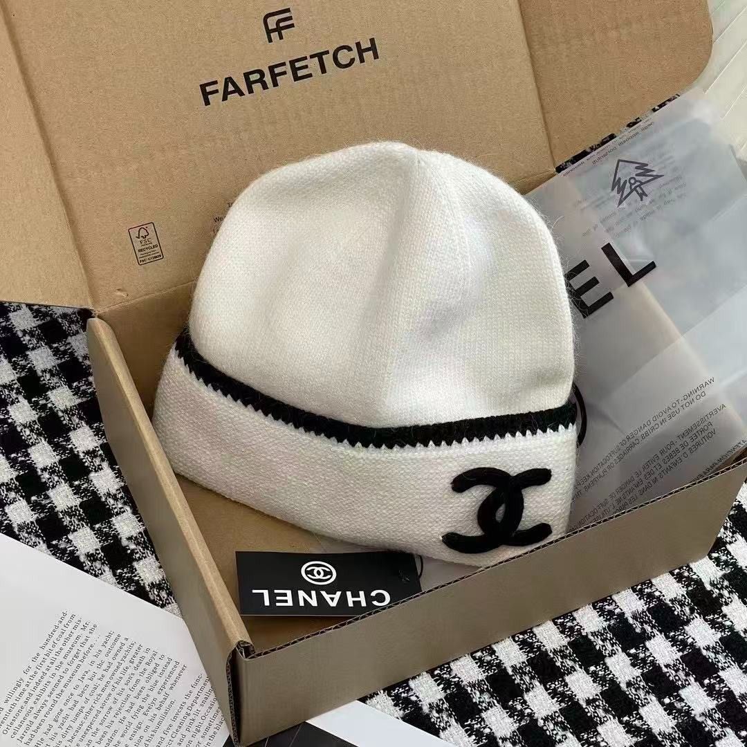 Chanel white and black knit beanie hat (Category: Hats & Beanies) located in Caloocan City. Submitted by rarisganiy26807 (Listing ID 1468132620, Image 1). Description: - Color: White with chic black contrast trim - Design: Iconic black interlocking CC logo stitched on the front - Material: Ultra-soft, cozy woolen texture - Inclusions: Brand new with tag and original Farfetch box - Condition: 100% Brand New, never worn.
