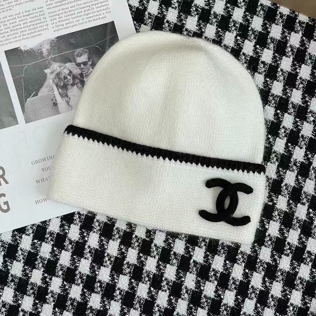 Chanel white and black knit beanie hat (Category: Hats & Beanies) located in Caloocan City. Submitted by rarisganiy26807 (Listing ID 1468132620, Image 2). Description: - Color: White with chic black contrast trim - Design: Iconic black interlocking CC logo stitched on the front - Material: Ultra-soft, cozy woolen texture - Inclusions: Brand new with tag and original Farfetch box - Condition: 100% Brand New, never worn.