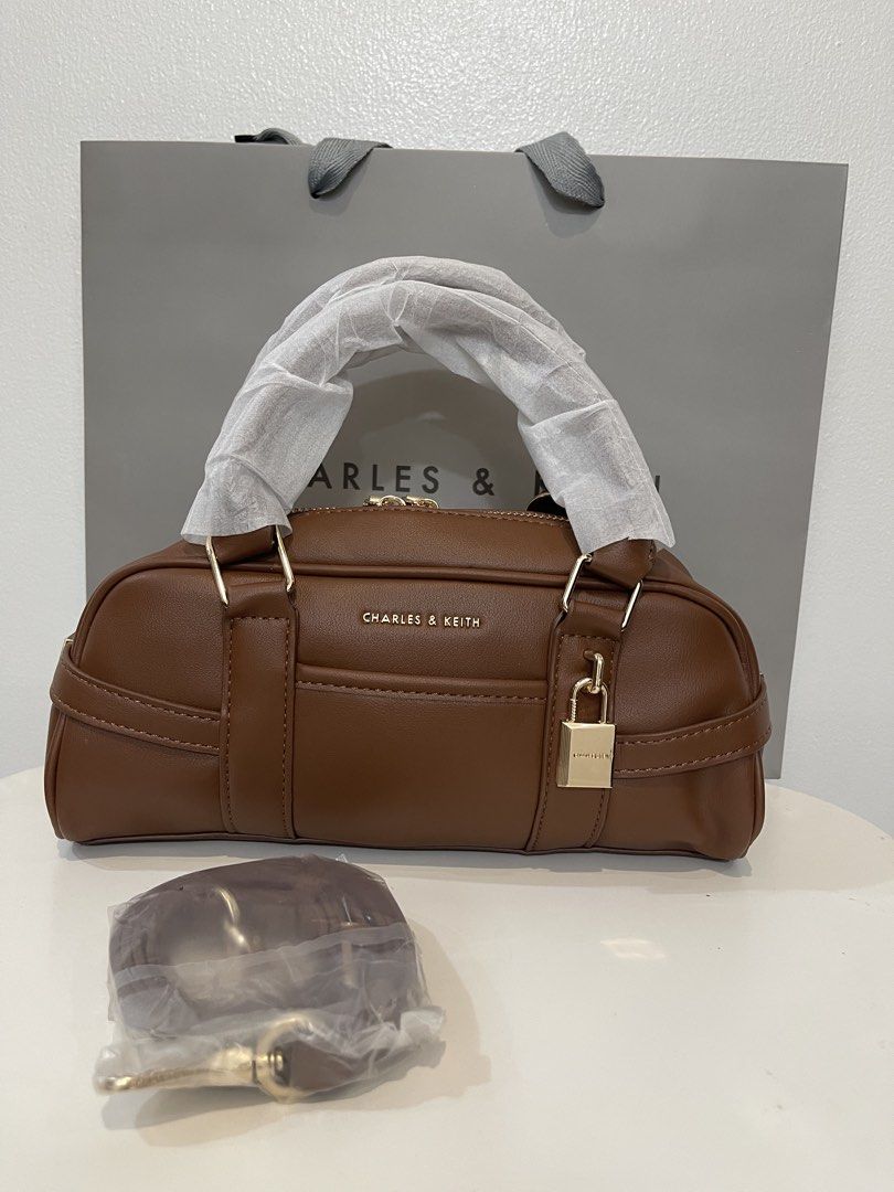 Charles & Keith Bowling Bag - Brown (Category: Shoulder Bags) located in Pasig City. Submitted by preloved.closet2 (Listing ID 1468085935, Image 1). Description: Bowling bag With Sling straps Color Brown Add paperbag plus 80 .