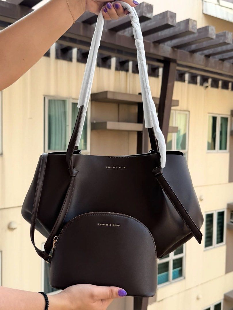 Charles & Keith Dark Brown Tote Bag with Pouch (Category: Tote Bags) located in Manila. Submitted by fritzieeeeeganda (Listing ID 1468102544, Image 3). Description: - Brand: Charles & Keith - Color: Dark brown - Inclusions: Matching half-moon pouch - Design: Structured slouchy style with thin shoulder straps - Perfect for: Daily commute, school essentials, or everyday use.