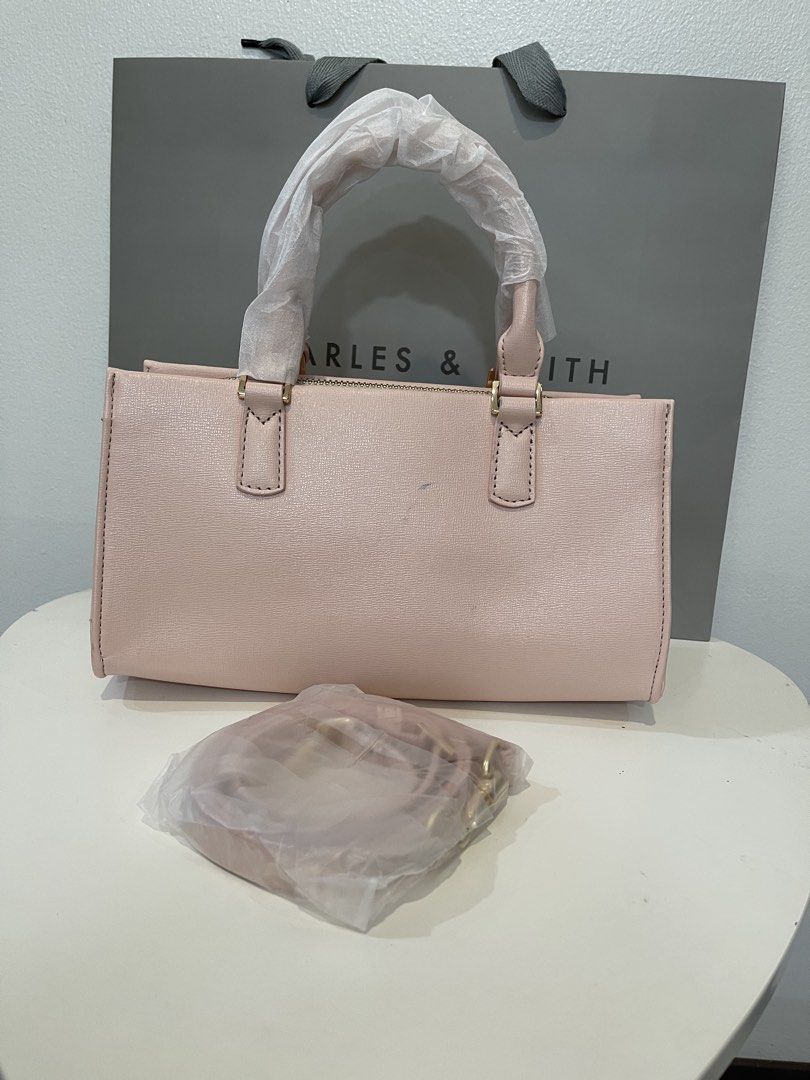 Charles & Keith Kerry Tote Bag - Pink (Category: Shoulder Bags) located in Pasig City. Submitted by preloved.closet2 (Listing ID 1468084853, Image 2). Description: Brand New Minor Ink stain on the backside Color pink with sling Add paperbag plus 80 .