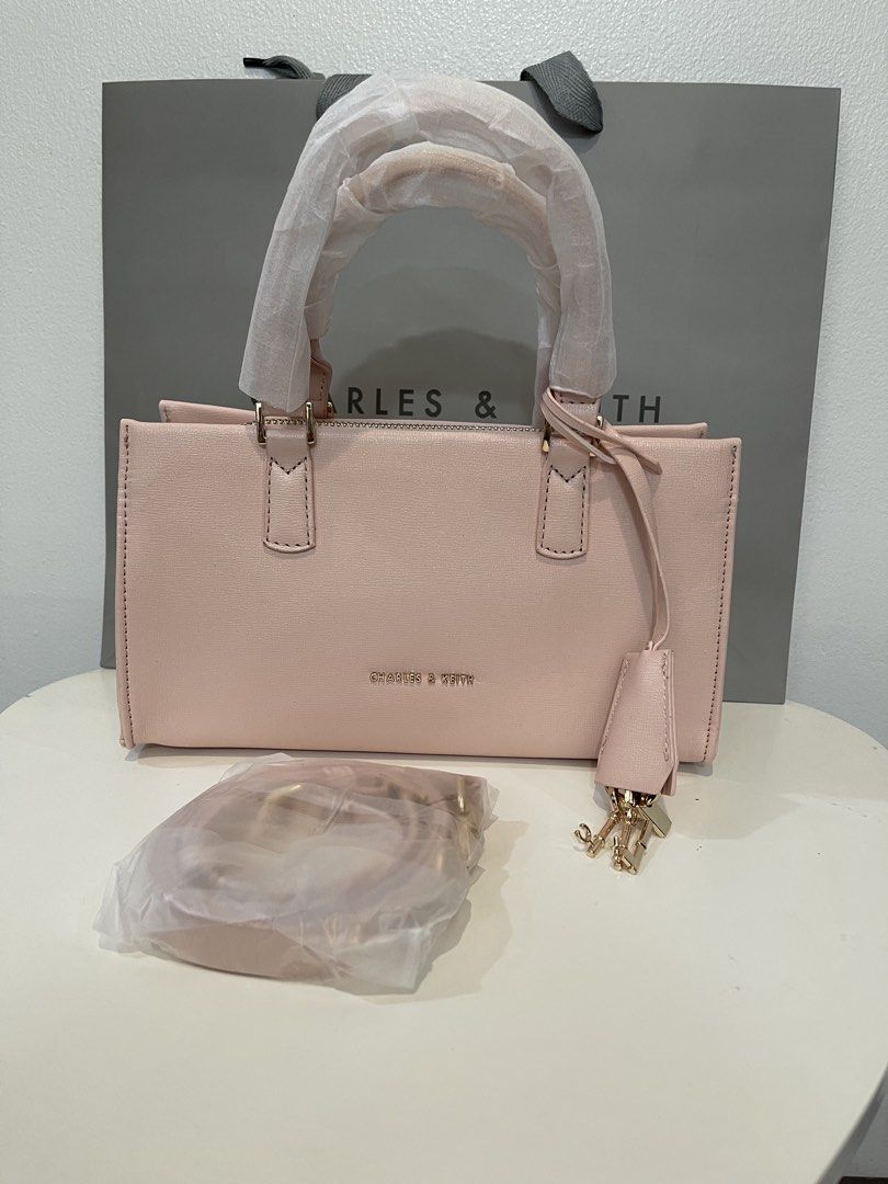 Charles & Keith Kerry Tote Bag - Pink (Category: Shoulder Bags) located in Pasig City. Submitted by preloved.closet2 (Listing ID 1468084853, Image 1). Description: Brand New Minor Ink stain on the backside Color pink with sling Add paperbag plus 80 .
