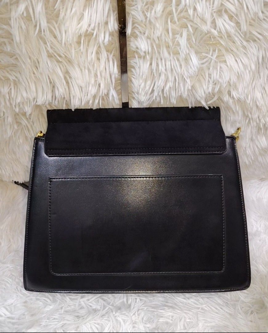 Charles & Keith Semi Large Black Shoulder Bag (Category: Shoulder Bags) located in Quezon City. Submitted by zhelcloset01 (Listing ID 1468059642, Image 3). Description: - Brand: Charles & Keith - Color: Classic Black - Style: Semi-large shoulder bag with flap front and gold-tone clasp - Material: Suede texture top flap with smooth leather body - Interior: Divided compartments with a secure zippered middle pocket - Exterior: Convenient back slip p
