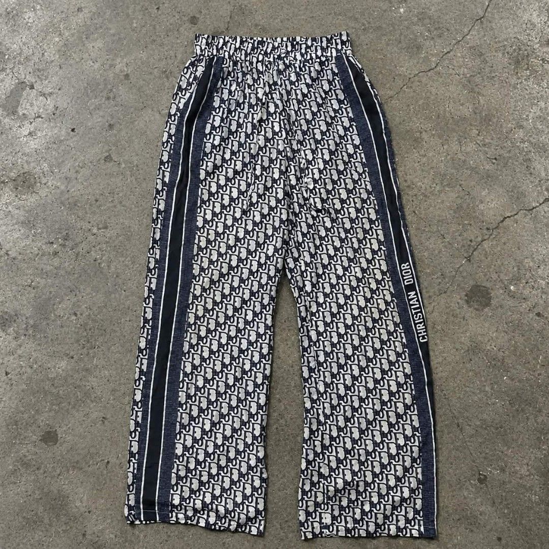 Christian Dior Monogram Pattern Wide Leg Lounge Pants (Category: Luxury Apparel) located in Manila. Submitted by gemfinds650 (Listing ID 1468154680, Image 1). Description: - Brand: Christian Dior - Style: All-over monogram lounge pants with a comfortable wide-leg fit - Waistband: Stretchable elastic for all-day comfort - Details: Dark blue side stripes with signature Christian Dior branding text on the right leg - Material: Lightweight fabric, id