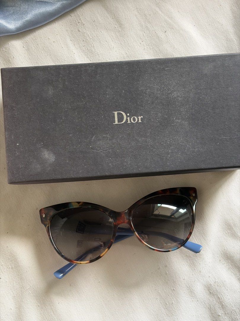 Christian Dior Tortoiseshell Sunglasses with Blue Temples (Category: Sunglasses & Eyewear) located in Pasig City. Submitted by sherlock2024 (Listing ID 1468062163, Image 2). Description: - Brand: Christian Dior Designer Sunglasses - Frame: Tortoiseshell front with contrasting blue temples - Lenses: Dark gradient - Details: Silver Dior logo lettering on the sides - Inclusions: Original black branded box - Condition: Excellent / Well-maintained - S