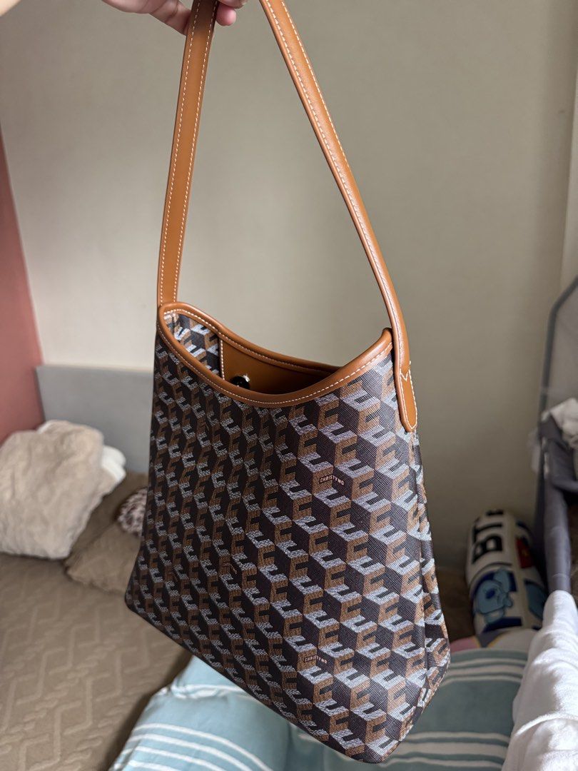Christy Ng Medium Alesso Hobo Bag (Category: Shoulder Bags) located in Manila. Submitted by realprelovedbylmhr (Listing ID 1468097592, Image 2). Description: - Brand: Christy Ng - Design: Brown geometric monogram pattern with tan leather-look trim and white contrast stitching - Structure: Open top design with a sleek, structured shape - Interior: Brown fabric lining with a convenient zip pocket - Condition: Clean exterior and interior, well-maint
