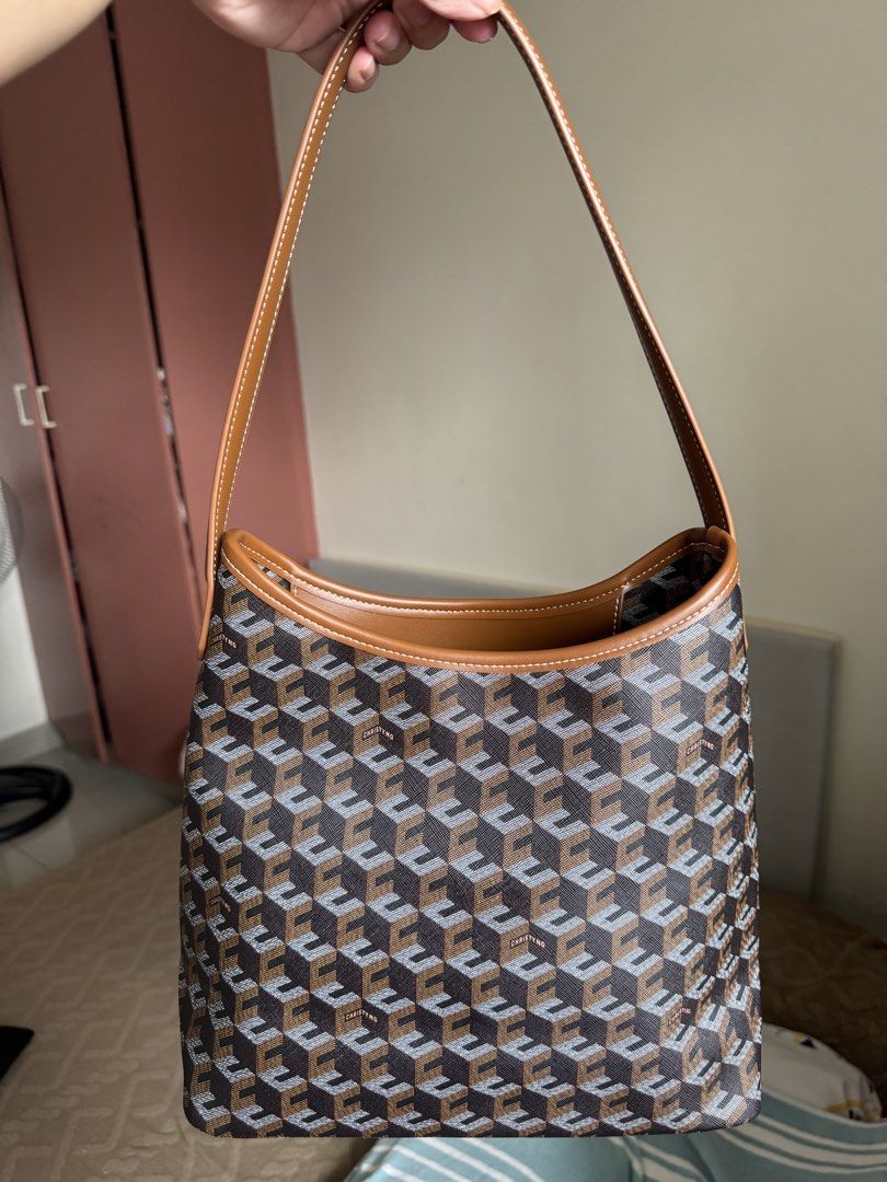 Christy Ng Medium Alesso Hobo Bag (Category: Shoulder Bags) located in Manila. Submitted by realprelovedbylmhr (Listing ID 1468097592, Image 1). Description: - Brand: Christy Ng - Design: Brown geometric monogram pattern with tan leather-look trim and white contrast stitching - Structure: Open top design with a sleek, structured shape - Interior: Brown fabric lining with a convenient zip pocket - Condition: Clean exterior and interior, well-maint
