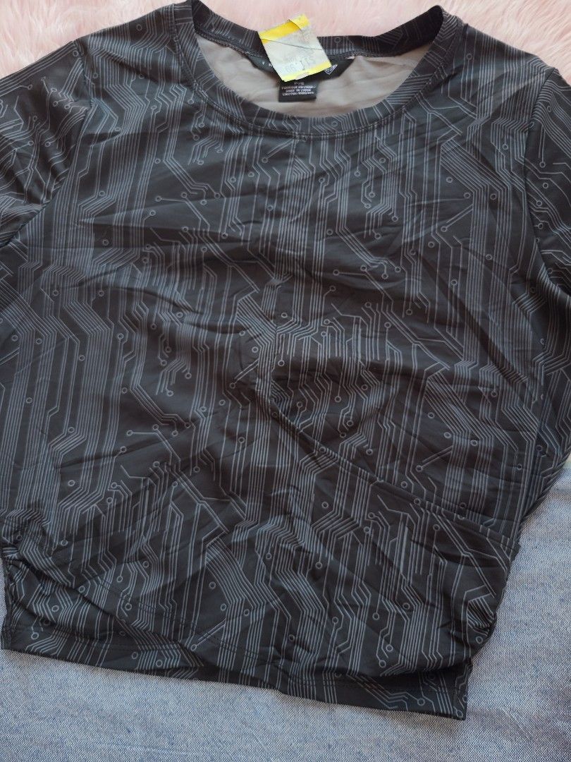 Circuit Board Pattern Long Sleeve Top (Category: Longsleeves) located in Lingayen. Submitted by chloeswhite (Listing ID 1468105929, Image 3). Description: - Color & Print: Black with an all-over grey circuit board print - Design: Round neckline with a trendy wrapped cropped hem - Fit & Sizing: Measures about 18 inches across the chest; material has some stretch - Condition: Brand new with original store tag still attached on the collar.