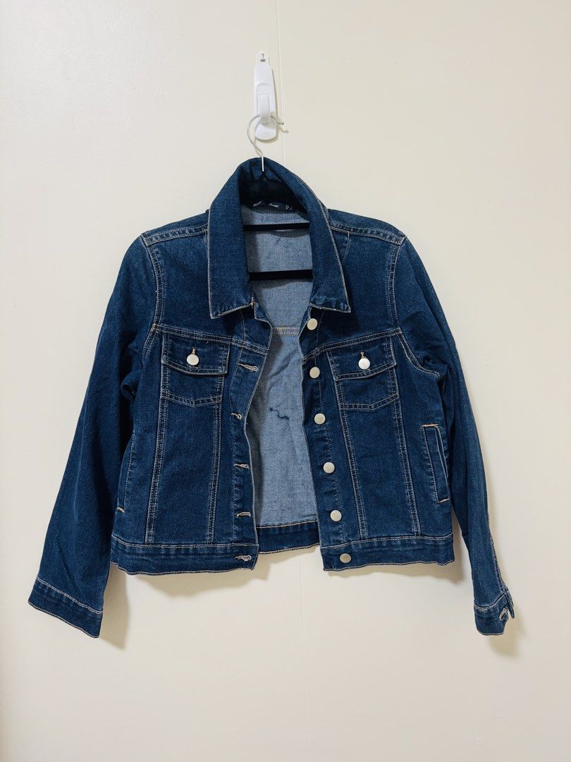 Classic Dark Blue Denim Jacket (Category: Coats, Jackets and Outerwear) located in Manila. Submitted by gotlistedph (Listing ID 1468192891, Image 1). Description: - Color: Dark blue - Closure: Front button closure - Pockets: Two chest pockets and side pockets - Details: Contrast stitching along seams, classic collar design, and buttoned cuffs - Fit: Easy to layer over tees or dresses for casual days.