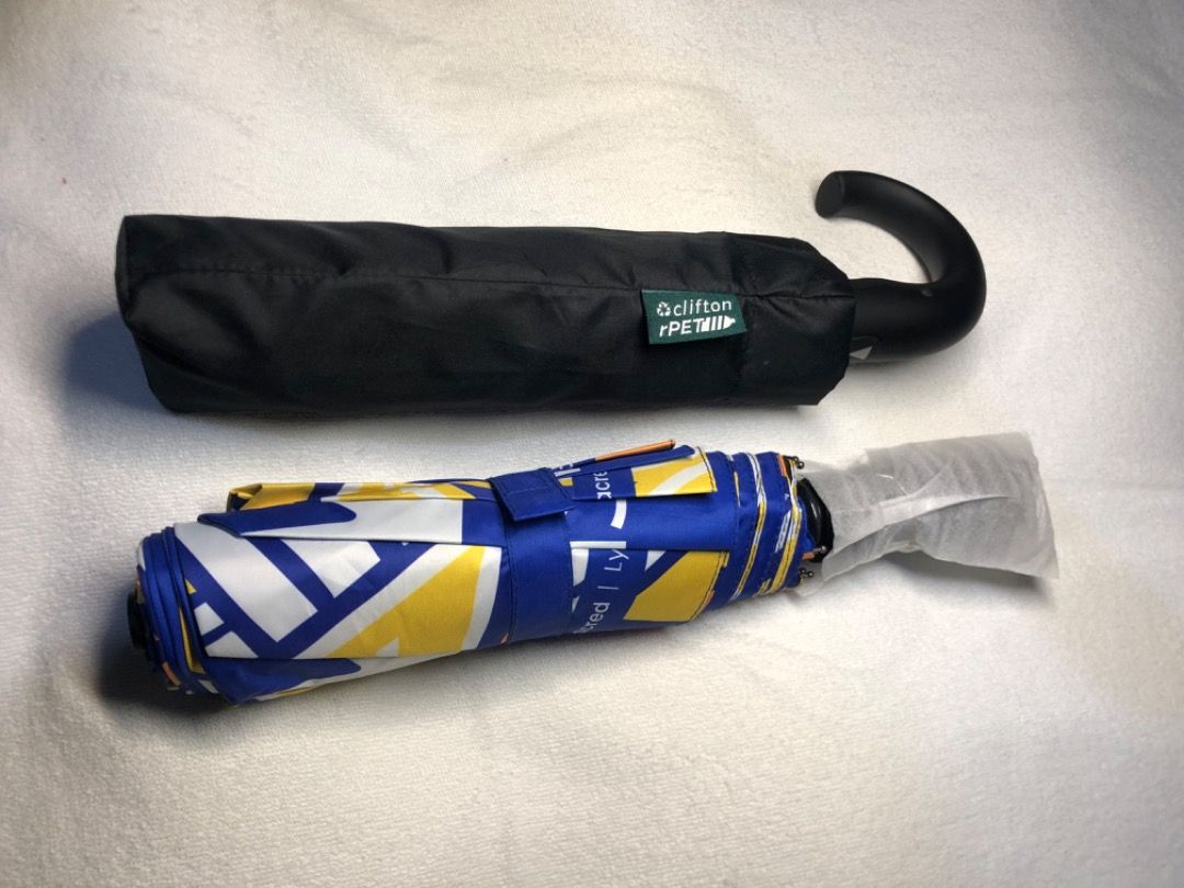 Clifton rPET Blue Yellow Patterned Folding Umbrella With Case (Category: Umbrellas) located in Cavite. Submitted by puredolphin.2b4cb1 (Listing ID 1468145446, Image 1). Description: - Brand: Clifton rPET - Condition: Brand new, unused, handle still wrapped in protective plastic - Design: Vibrant blue and yellow pattern with a convenient hook handle - Inclusion: Comes with a matching black storage sleeve featuring a green brand tag - Portability: 