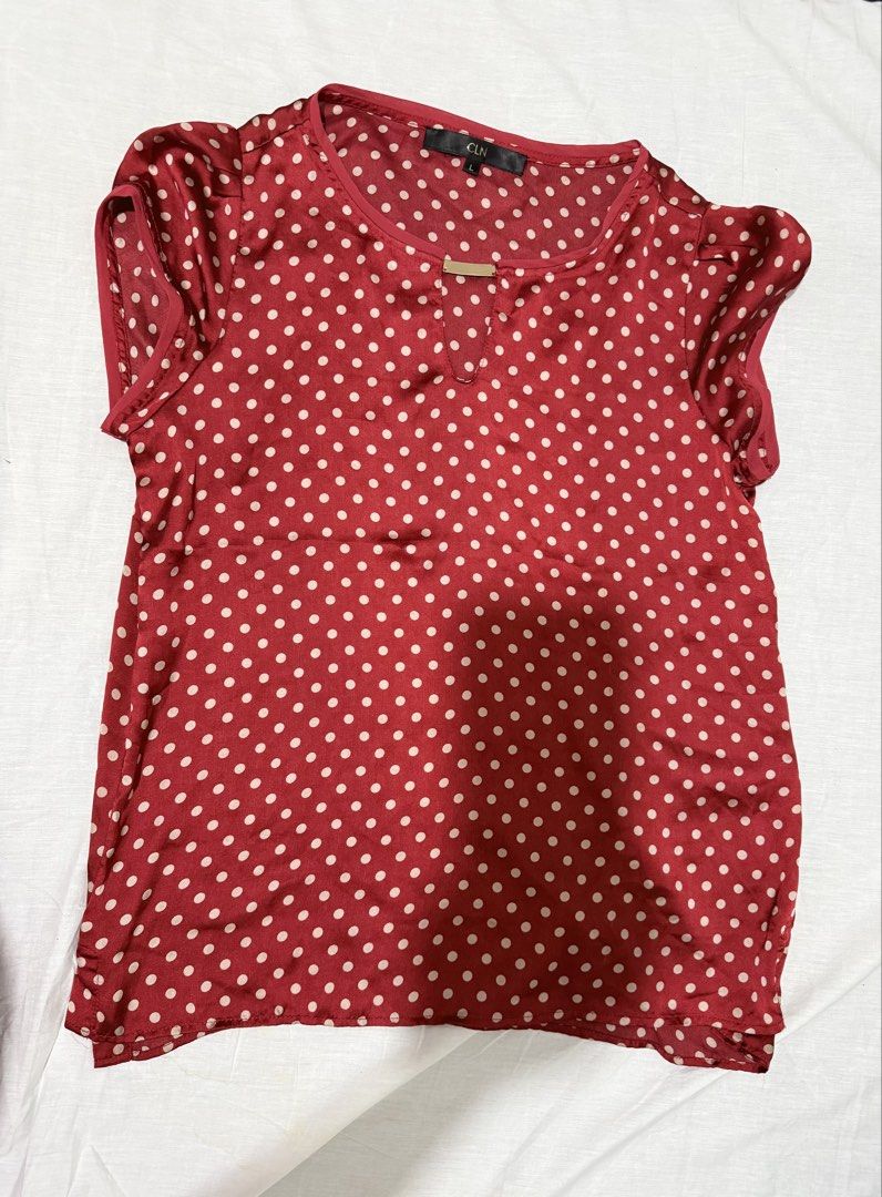 CLN Red Polka Dot Blouse Size L (Category: Blouses) located in Santa Rosa. Submitted by pauiofficial (Listing ID 1468063396, Image 2). Description: - Brand: CLN - Color/Pattern: Red and white polka dot - Size: Large - Sleeves: Short cap sleeves with gathered shoulder detail - Neckline: Keyhole with a chic gold-tone metal bar accent - Fit: Lightweight fabric, easy to tuck in or wear untucked.