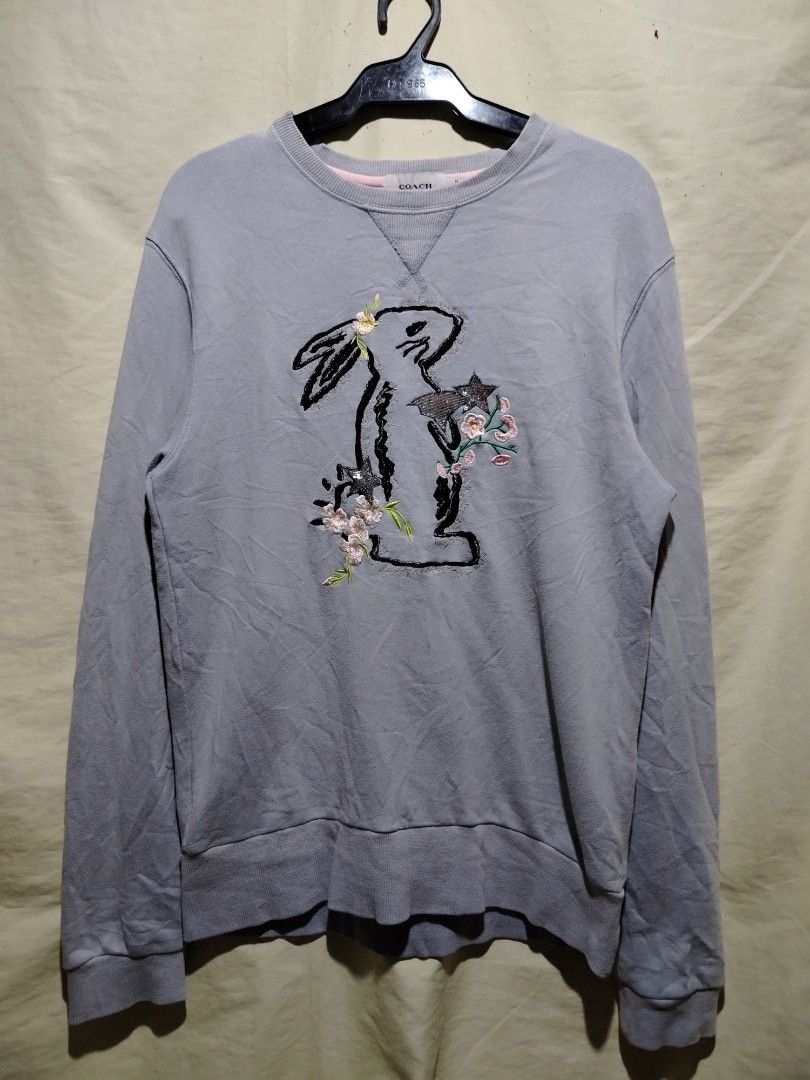 Coach 1941 Rabbit Embroidered Light Blue Sweatshirt Size 50 (Category: Coats, Jackets and Outerwear) located in Caloocan City. Submitted by vincefresn21903 (Listing ID 1468281859, Image 1). Description: - Brand: Coach 1941 - Color: Light Blue with rabbit embroidery and floral details - Size: 50 (tag attached) - Material: 100% cotton - Features: Ribbed crewneck, cuffs, and hem - Care: Wash inside out in cold water - Condition: Made in China, well-