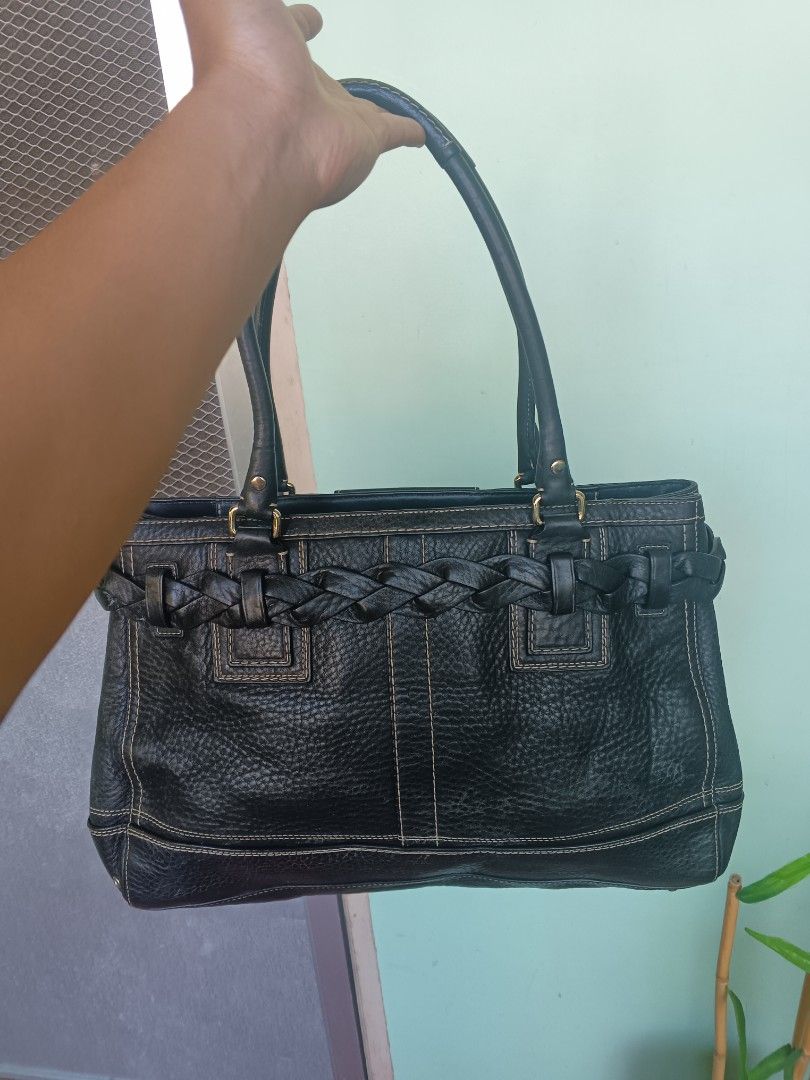 Coach Black Leather braided Tote Shoulder Bag (Category: Shoulder Bags) located in Bayombong. Submitted by jnjthriftshop123 (Listing ID 1468101733, Image 2). Description: Coach black pebble leather shoulder bag with gold hardware. Braided strap detail across the front, matching leather tassel, and classic Coach hangtag. Double shoulder straps with sturdy drop. Contrast stitching throughout. Bottom studs protect the base from scuffs. Spacious inte