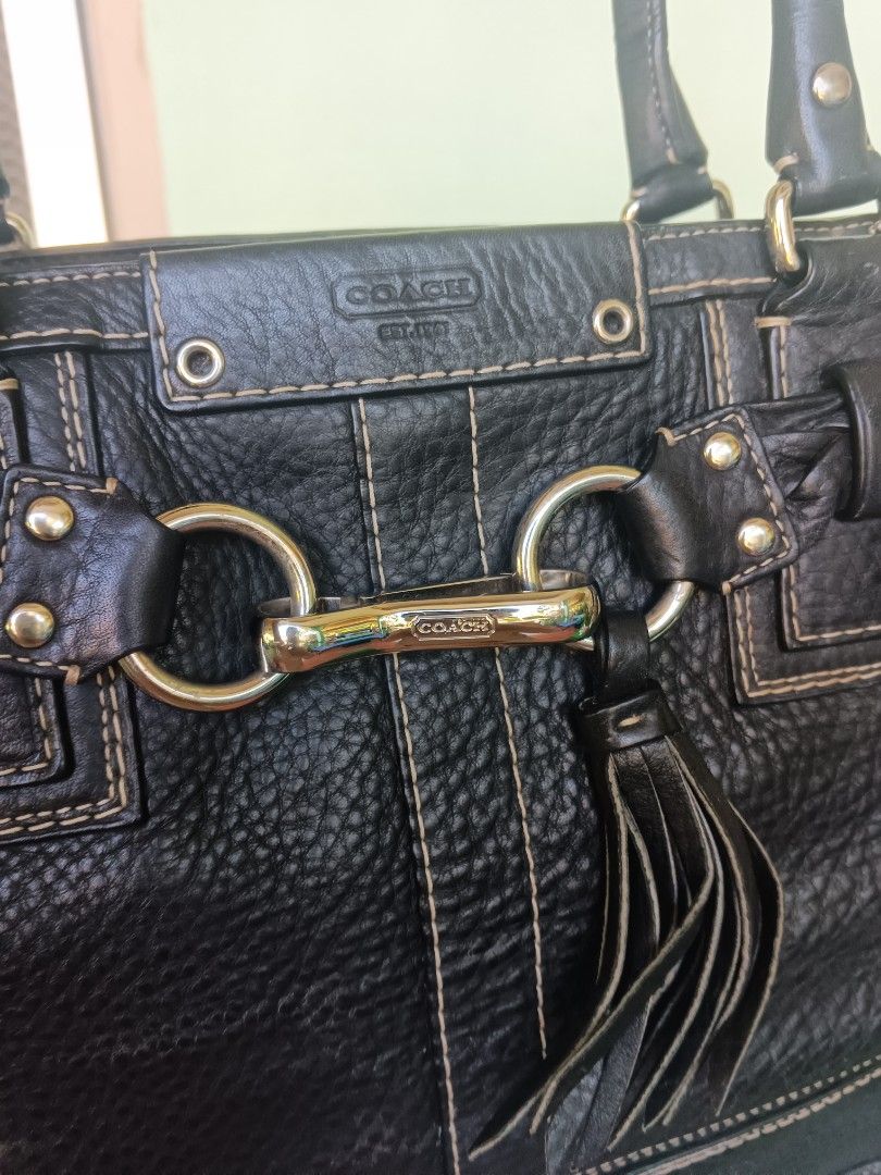 Coach Black Leather braided Tote Shoulder Bag (Category: Shoulder Bags) located in Bayombong. Submitted by jnjthriftshop123 (Listing ID 1468101733, Image 3). Description: Coach black pebble leather shoulder bag with gold hardware. Braided strap detail across the front, matching leather tassel, and classic Coach hangtag. Double shoulder straps with sturdy drop. Contrast stitching throughout. Bottom studs protect the base from scuffs. Spacious inte