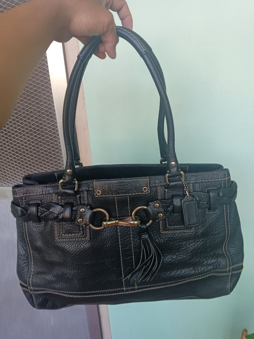 Coach Black Leather braided Tote Shoulder Bag (Category: Shoulder Bags) located in Bayombong. Submitted by jnjthriftshop123 (Listing ID 1468101733, Image 1). Description: Coach black pebble leather shoulder bag with gold hardware. Braided strap detail across the front, matching leather tassel, and classic Coach hangtag. Double shoulder straps with sturdy drop. Contrast stitching throughout. Bottom studs protect the base from scuffs. Spacious inte