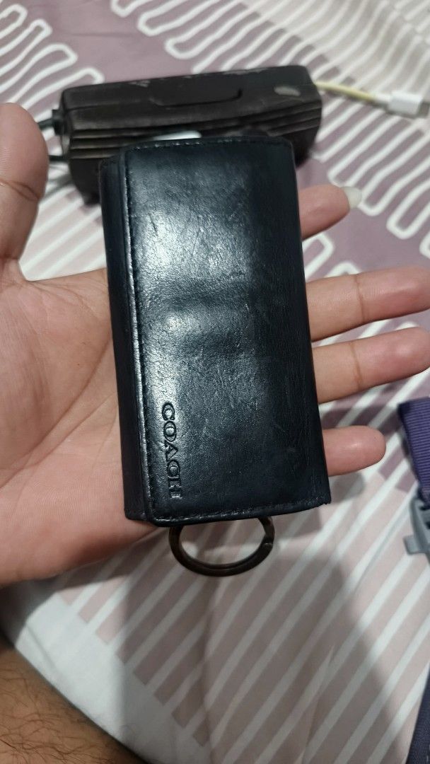 Coach Black Leather Key Case Holder (Category: Wallets & Card holders) located in Manila. Submitted by dyastenthrift (Listing ID 1468212203, Image 1). Description: - Brand: Coach - Material: Genuine black leather - Closure: Snap button - Interior: Key hooks and card slots for extra functionality - Extras: Attached keyring at the bottom - Design: Stamped Coach branding on front and interior - Origin: Made in China - Size: Compact and pocket-friend