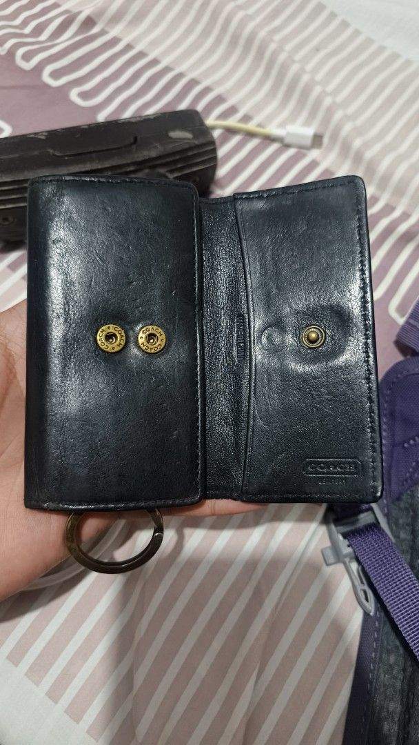 Coach Black Leather Key Case Holder (Category: Wallets & Card holders) located in Manila. Submitted by dyastenthrift (Listing ID 1468212203, Image 2). Description: - Brand: Coach - Material: Genuine black leather - Closure: Snap button - Interior: Key hooks and card slots for extra functionality - Extras: Attached keyring at the bottom - Design: Stamped Coach branding on front and interior - Origin: Made in China - Size: Compact and pocket-friend