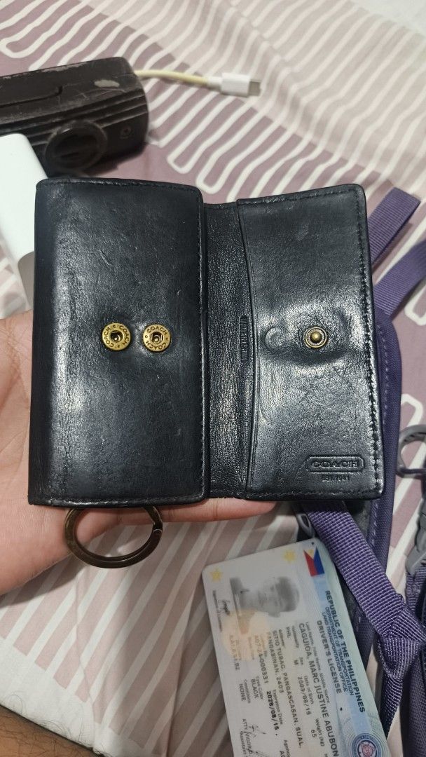 Coach Black Leather Key Case Holder (Category: Wallets & Card holders) located in Manila. Submitted by dyastenthrift (Listing ID 1468212203, Image 3). Description: - Brand: Coach - Material: Genuine black leather - Closure: Snap button - Interior: Key hooks and card slots for extra functionality - Extras: Attached keyring at the bottom - Design: Stamped Coach branding on front and interior - Origin: Made in China - Size: Compact and pocket-friend