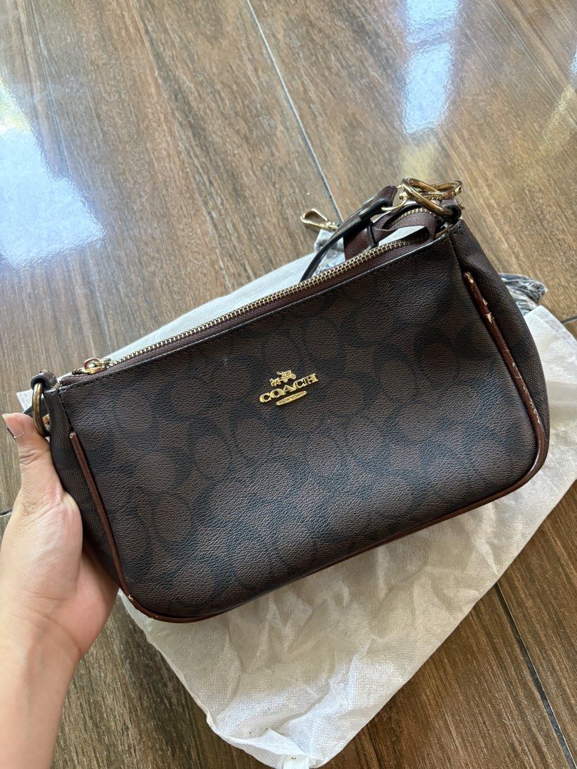 Coach Brown Signature Monogram Shoulder Bag (Category: Shoulder Bags) located in Marikina City. Submitted by hey_girlies (Listing ID 1468084079, Image 2). Description: - Coach monogram shoulder bag in classic dark brown signature canvas - Elegant gold-tone hardware and secure top zip closure - Fabric-lined interior featuring a zip pocket and official Coach leather creed patch - Includes attached short handle strap - Comes with an extra long detac