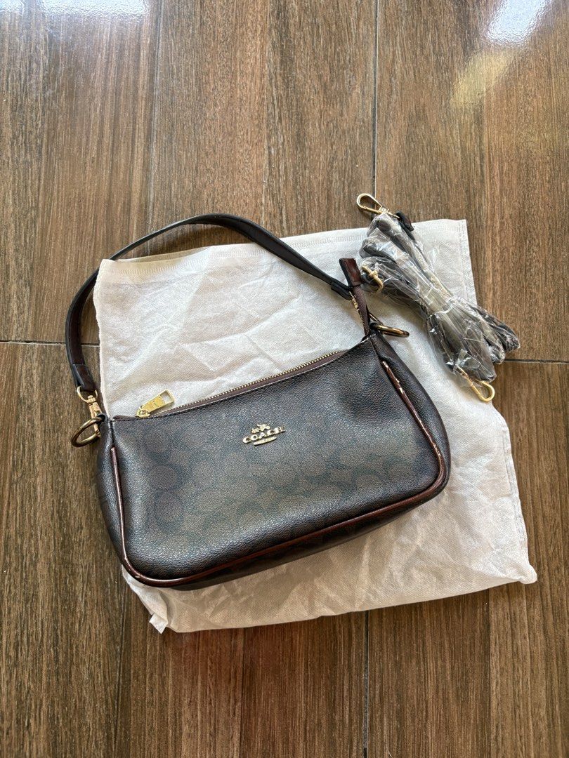 Coach Brown Signature Monogram Shoulder Bag (Category: Shoulder Bags) located in Marikina City. Submitted by hey_girlies (Listing ID 1468084079, Image 1). Description: - Coach monogram shoulder bag in classic dark brown signature canvas - Elegant gold-tone hardware and secure top zip closure - Fabric-lined interior featuring a zip pocket and official Coach leather creed patch - Includes attached short handle strap - Comes with an extra long detac