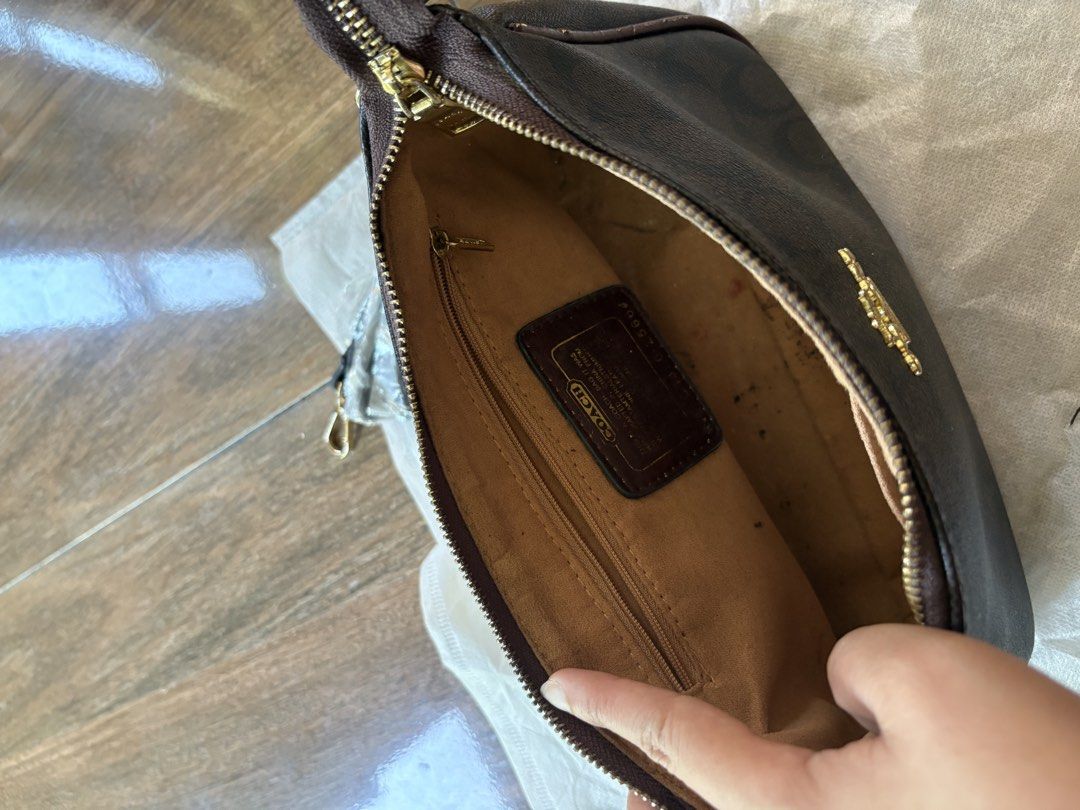 Coach Brown Signature Monogram Shoulder Bag (Category: Shoulder Bags) located in Marikina City. Submitted by hey_girlies (Listing ID 1468084079, Image 3). Description: - Coach monogram shoulder bag in classic dark brown signature canvas - Elegant gold-tone hardware and secure top zip closure - Fabric-lined interior featuring a zip pocket and official Coach leather creed patch - Includes attached short handle strap - Comes with an extra long detac