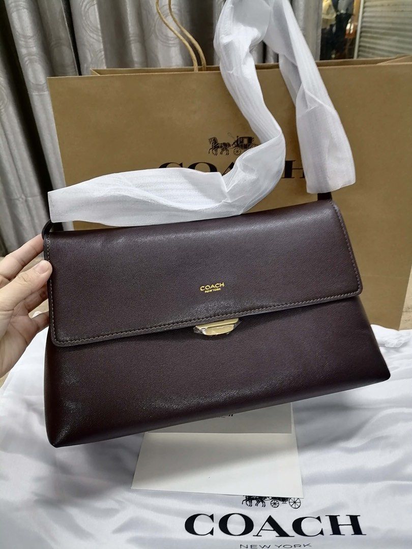 Coach Chelsea (Category: Shoulder Bags) located in Cavite. Submitted by lovedbypriley (Listing ID 1468066218, Image 1). Description: - Authentic Coach leather shoulder bag in rich dark brown - Size Small - Elegant flap closure with polished gold-tone hardware - Features the iconic gold Coach New York logo stamp on the front - Comes complete with the original shopping bag and dust cover - Premium copy not original.