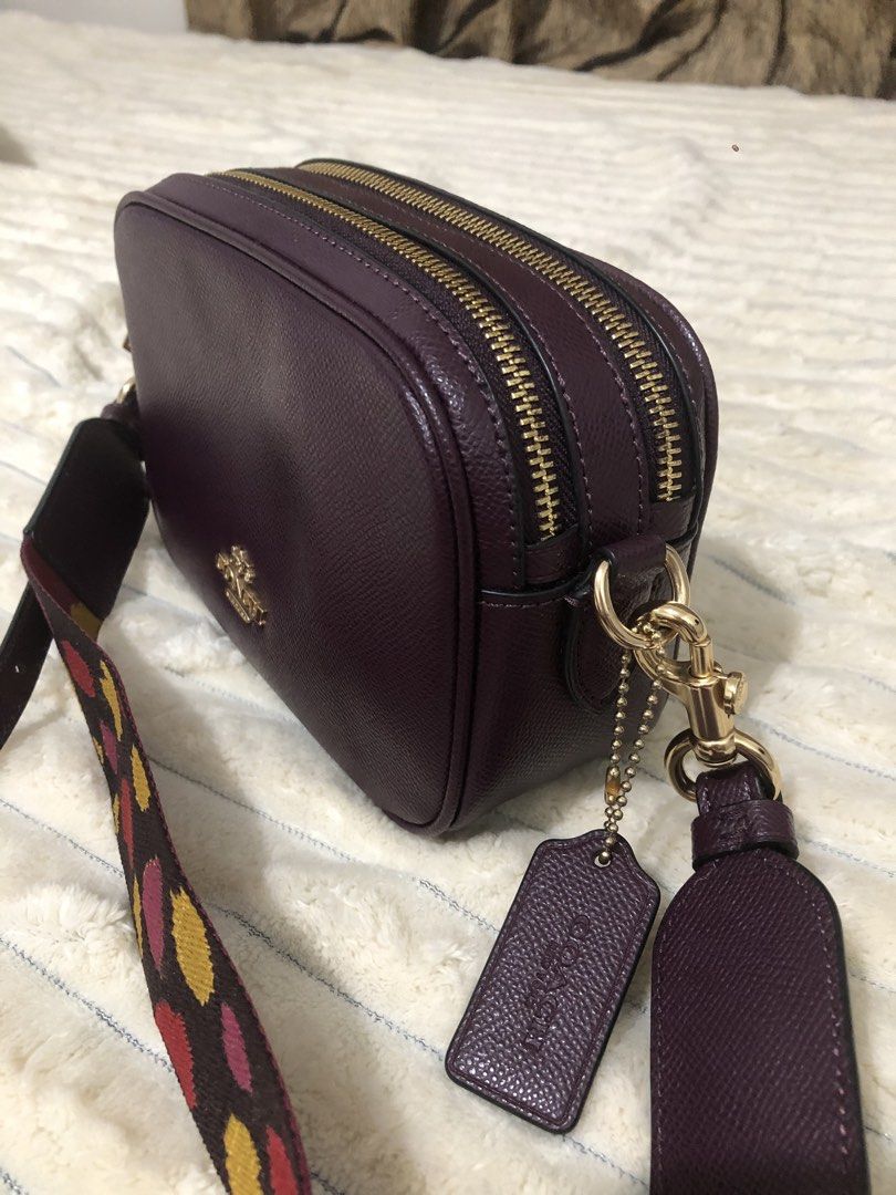 Coach Dark Purple Crossbody Bag with Patterned Strap (Category: Cross-body Bags) located in Rizal. Submitted by elviedc2420209 (Listing ID 1468201859, Image 3). Description: - Authentic Coach camera crossbody bag in deep purple crossgrain leather - Luxurious gold-tone hardware throughout - Dual zip compartments and convenient exterior back slip pocket - Includes a trendy, removable wide canvas strap with multicolored leopard print - Comes with si