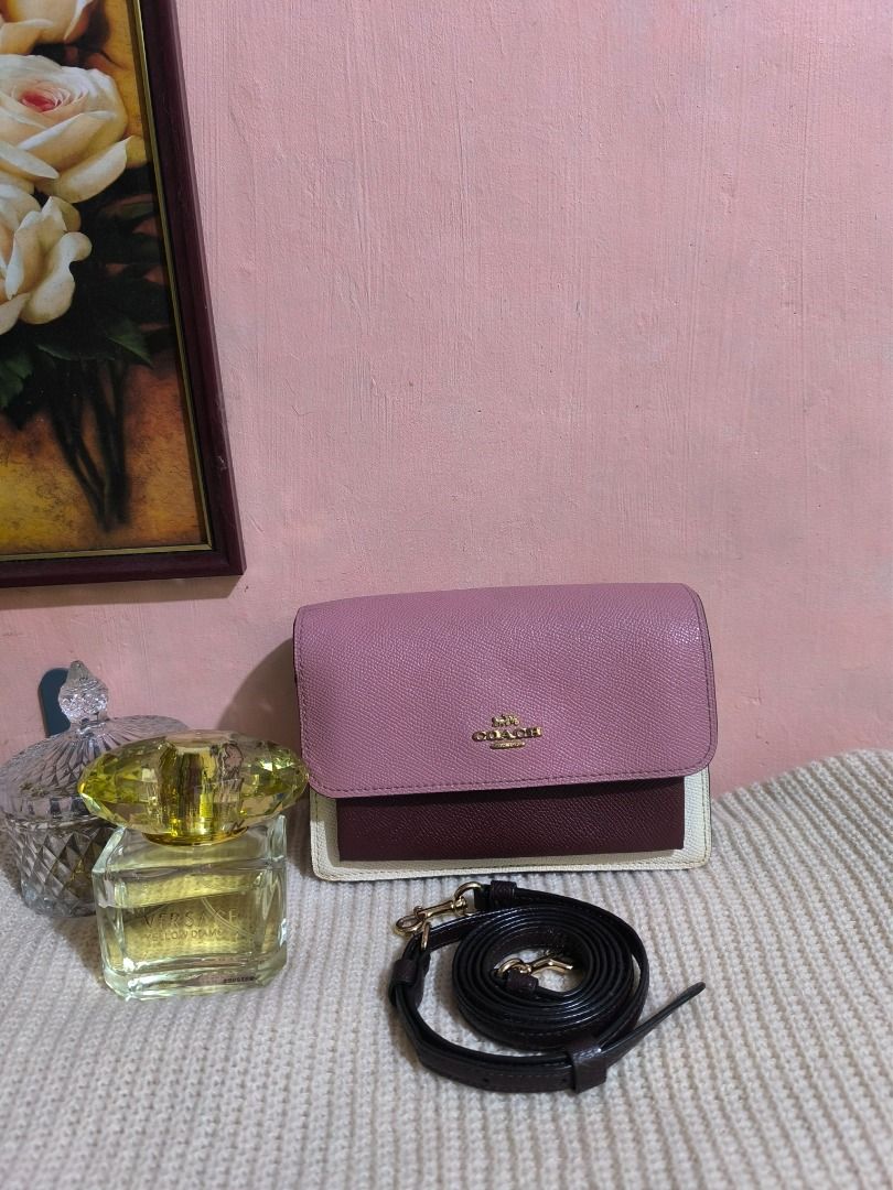 Coach Foldover Shoulder/Belt Bag (Category: Cross-body Bags) located in Cebu City. Submitted by re-amoreph_2014 (Listing ID 1468256262, Image 2). Description: - Brand: Coach - Style: Belt/Crossbody/Clutch bag - Colorway: Tri-color (Pink, Burgundy, and White) - Material: Textured leather with gold-tone hardware - Strap: Detachable dark brown leather strap included - Interior: Fabric lining with 1 slip pocket and 1 zipper compartment - Condition: C