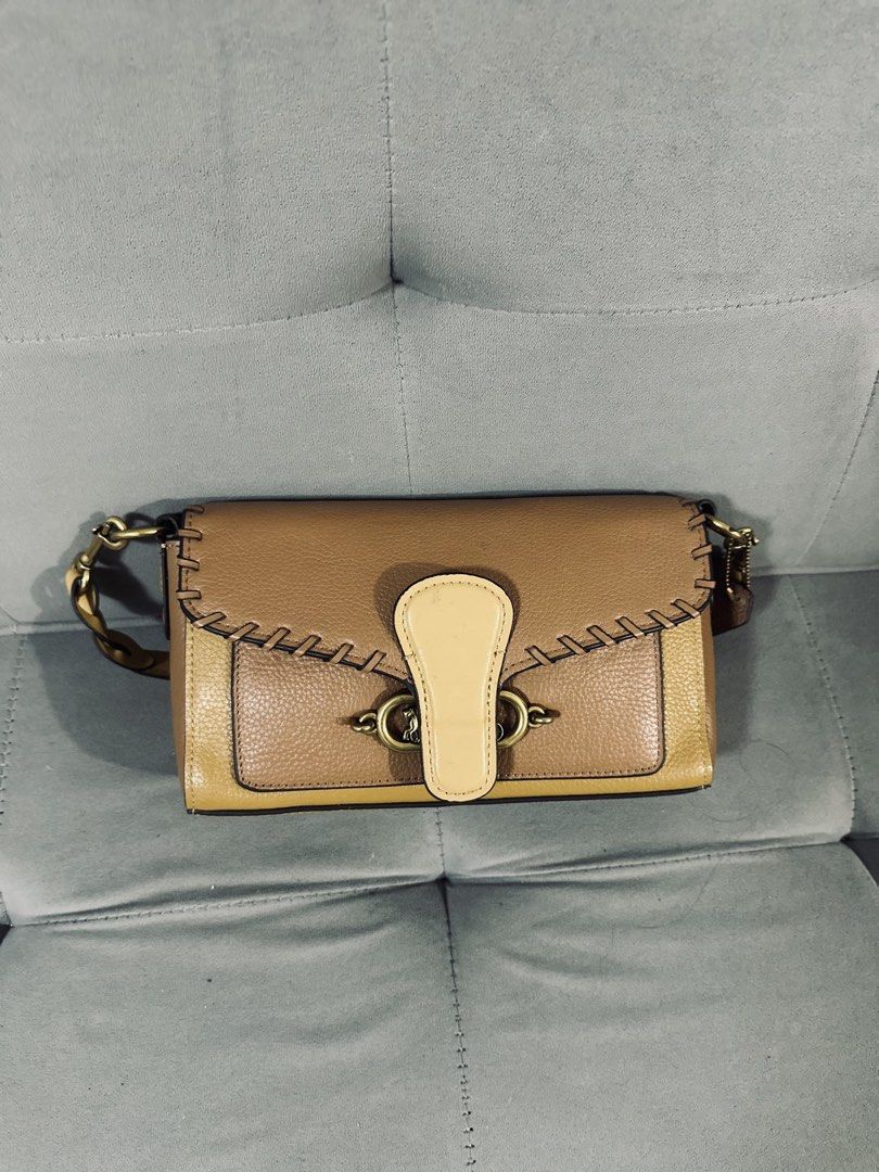 Coach Leather Crossbody Bag Tan Multicolour (Category: Cross-body Bags) located in Tarlac. Submitted by via_banana (Listing ID 1468095934, Image 1). Description: - Brand: Coach - Design: Tan and mustard colorblock with contrast whipstitch details - Closure: Turnlock closure on front flap - Interior: Bright red lining with a convenient slip pocket - Exterior: Back zipper pocket for extra storage - Hardware: Brass-tone hardware with signature strap