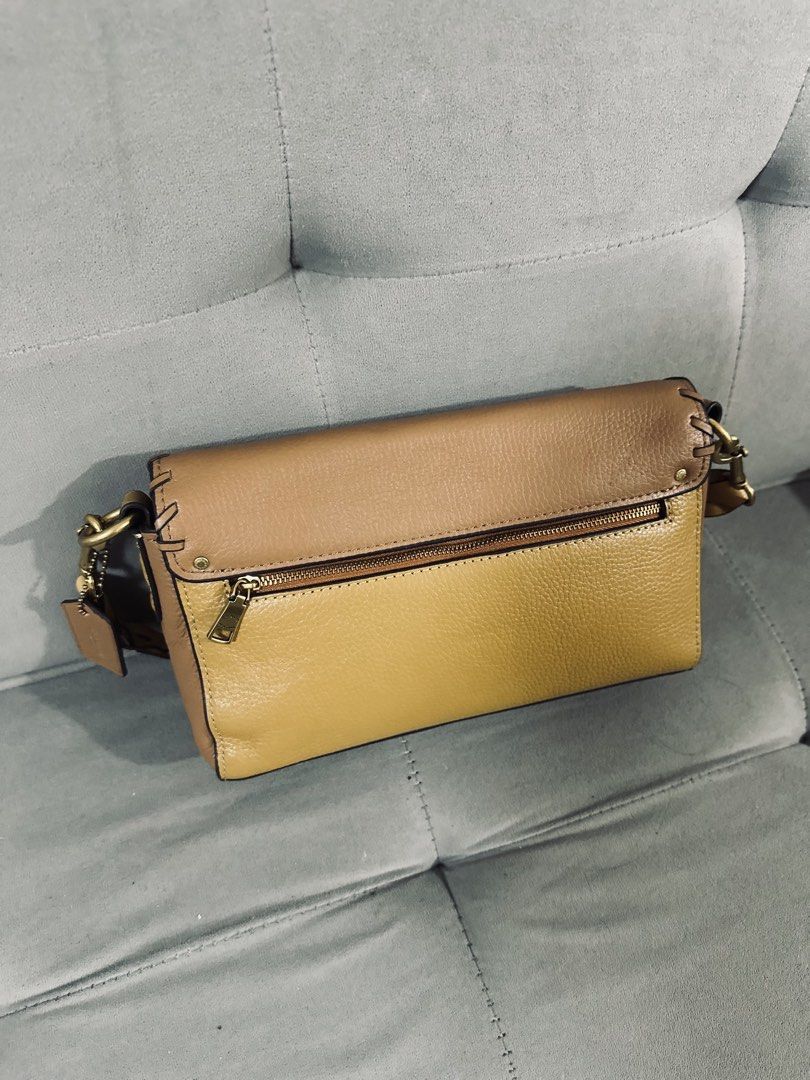 Coach Leather Crossbody Bag Tan Multicolour (Category: Cross-body Bags) located in Tarlac. Submitted by via_banana (Listing ID 1468095934, Image 2). Description: - Brand: Coach - Design: Tan and mustard colorblock with contrast whipstitch details - Closure: Turnlock closure on front flap - Interior: Bright red lining with a convenient slip pocket - Exterior: Back zipper pocket for extra storage - Hardware: Brass-tone hardware with signature strap
