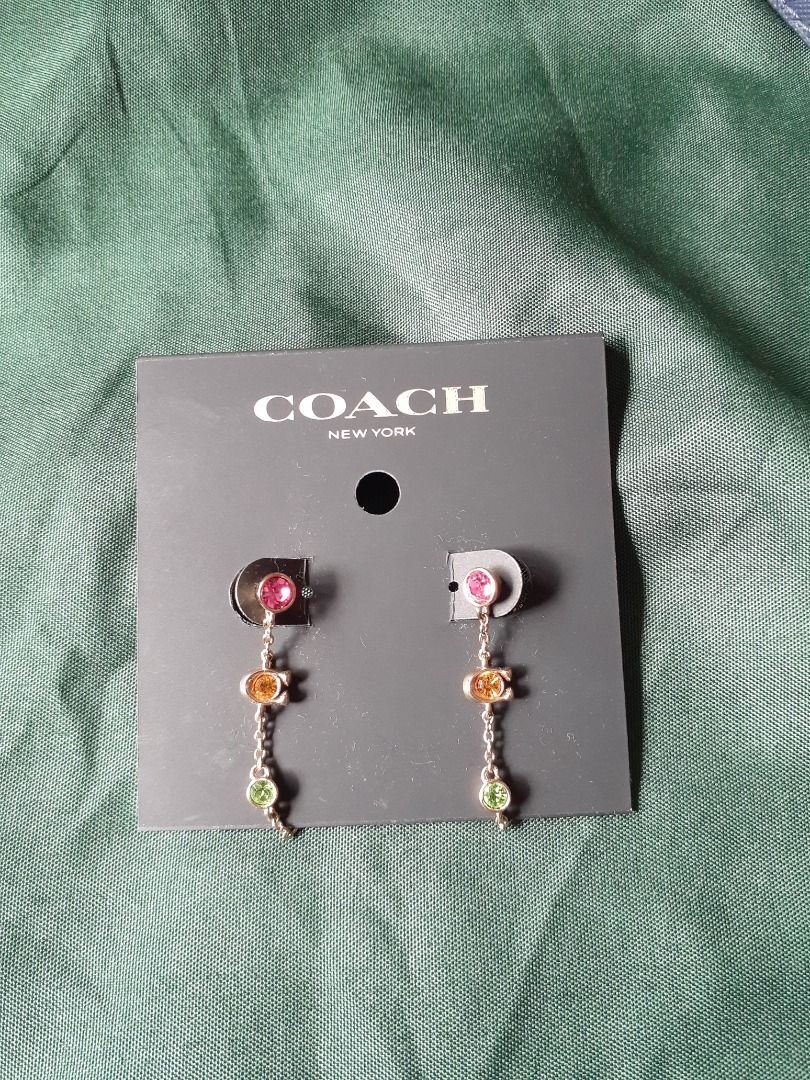 Coach Multi-color Crystal Chain Earrings (Category: Earrings) located in Bacolor. Submitted by paudvsells (Listing ID 1468201974, Image 1). Description: - Brand: Coach - Condition: Used twice - Design: Dangle earrings with pink top stone, orange 'C' logo charm, and green bottom stone - Hardware: Rose gold tone metal - Perfect for daily wear or as a gift.