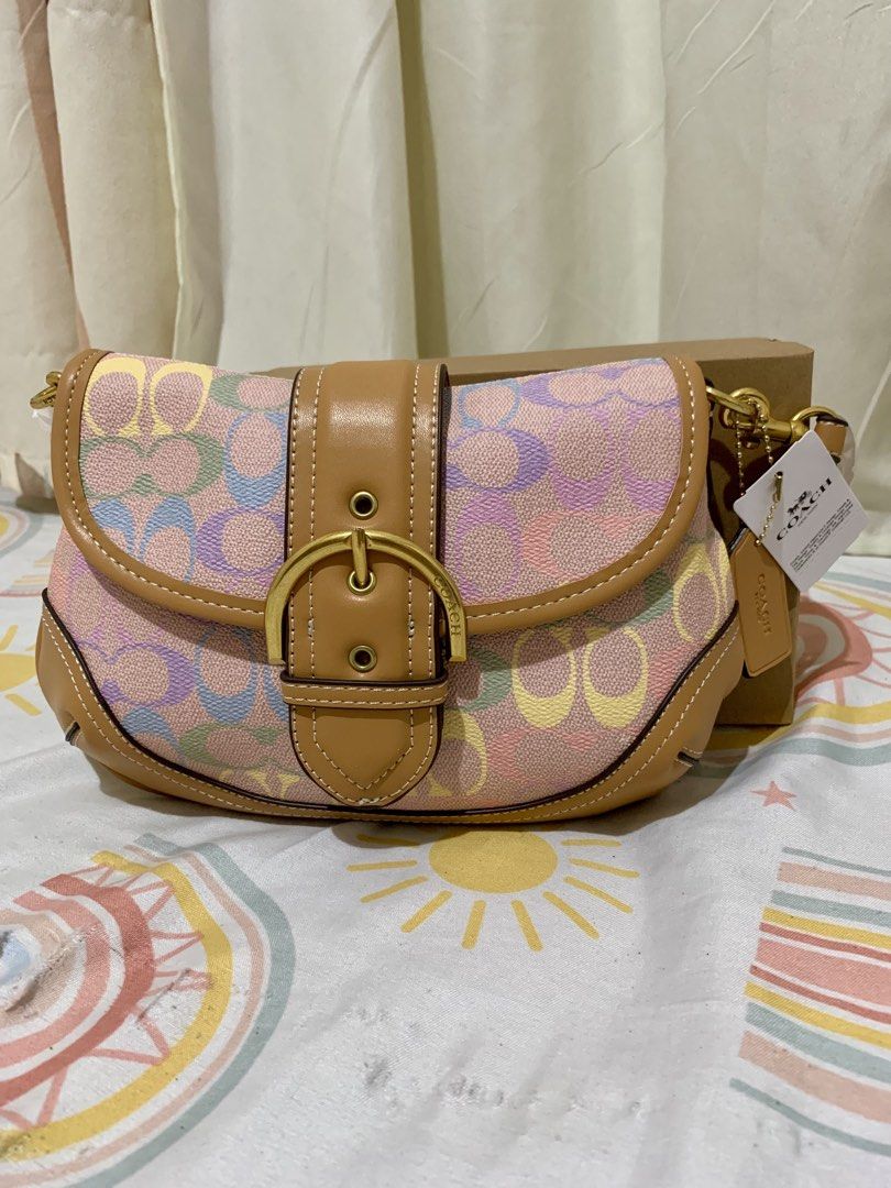 Coach Multi-color Signature Canvas Saddle Bag (Category: Clutches) located in San Mateo. Submitted by trendsph_956 (Listing ID 1468280695, Image 1). Description: - Coach signature canvas saddle bag - Fun multi-color pastel print with tan leather trim - Elegant gold-tone hardware and contrast white stitching - Secure front flap closure with magnetic snap - Comes with original leather hangtag, retail tag, and box.