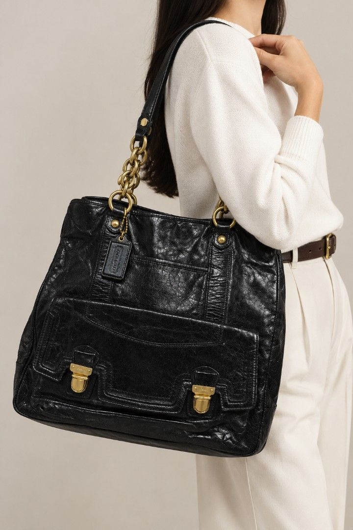 COACH POPPY PUSHLOCK LEATHER TOTE (17924) (Category: Luxury Bags & Wallets) located in Baguio. Submitted by PreiLoveMaria (Listing ID 1468204764, Image 1). Description: COACH POPPY PUSHLOCK LEATHER TOTE (17924) ​Crafted in glazed black distressed leather, this iconic Coach Poppy tote features statement brass chain shoulder straps, front flap push-lock compartments, and an unexpected pop of vibrant hot pink satin lining. Extremely spacious and per