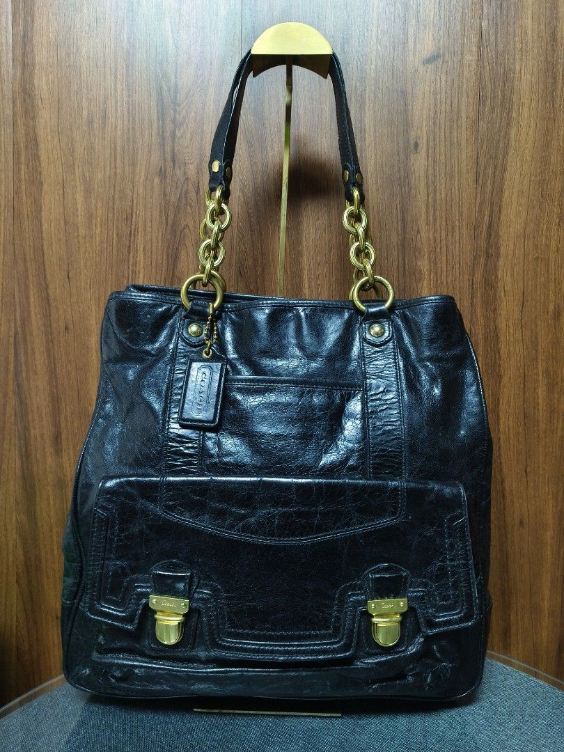 COACH POPPY PUSHLOCK LEATHER TOTE (17924) (Category: Luxury Bags & Wallets) located in Baguio. Submitted by PreiLoveMaria (Listing ID 1468204764, Image 2). Description: COACH POPPY PUSHLOCK LEATHER TOTE (17924) ​Crafted in glazed black distressed leather, this iconic Coach Poppy tote features statement brass chain shoulder straps, front flap push-lock compartments, and an unexpected pop of vibrant hot pink satin lining. Extremely spacious and per